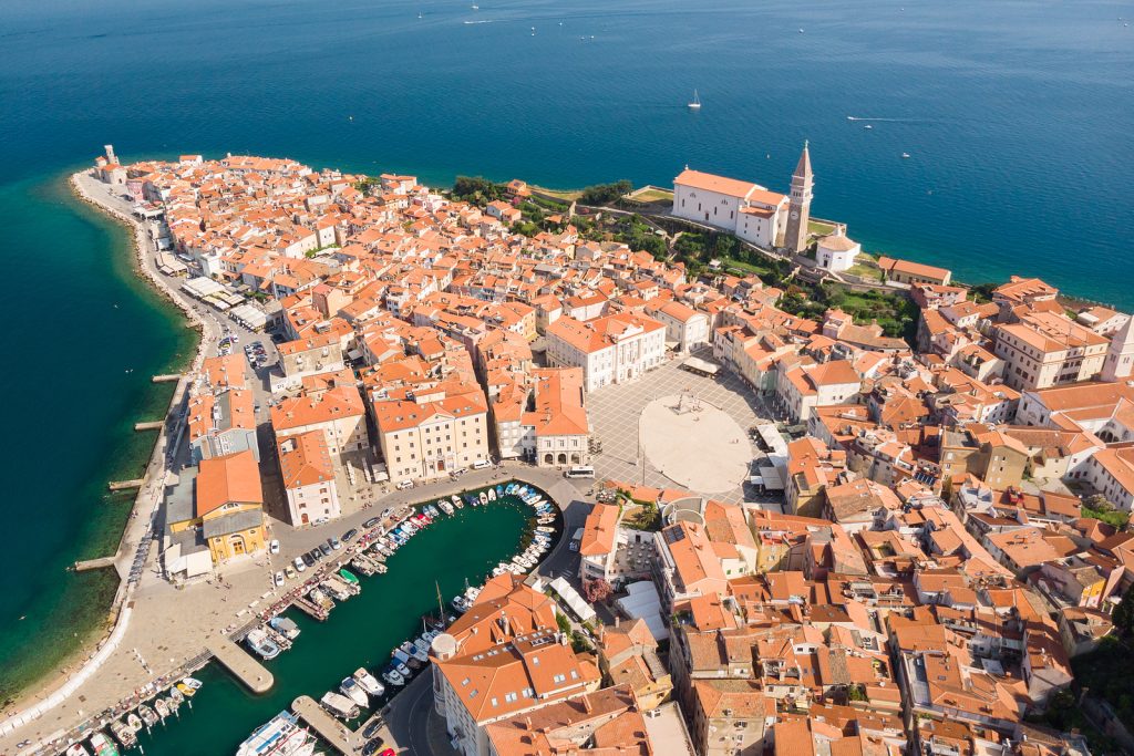 Aerial view of old town Piran. Splendid summer day on Adriatic Sea. Beautiful cityscape of Slovenia, Europe. Traveling concept background. Magnificent Mediterranean landscape.